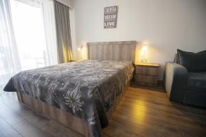 a bedroom with a large bed and a couch at Gudauri Cozy Home in Gudauri +50 photos