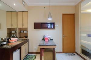 a kitchen with a sink and a counter top at Strategic and Comfy Studio at Grand Setiabudi Apartment By Travelio in Bandung