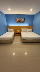 Postel nebo postele na pokoji v ubytování South of The Clouds HOTEL KL Sentral 吉隆坡彩云之南酒店-中央车站店