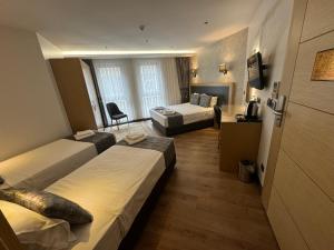 a hotel room with two beds and a chair at Gulec Hotel & Spa - Special Category in Istanbul
