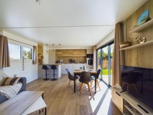 a living room and kitchen of a tiny house at Chalet pour 4 - Domaine avec piscine in Saint-Gilles-Croix-de-Vie
