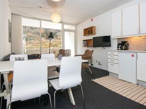 a kitchen and dining room with a table and chairs at 6 person holiday home in Ringkøbing in Ringkøbing