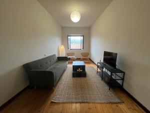 a living room with a couch and a television at Casa Zuccaro in Valduggia