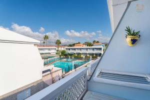 a balcony with a view of a swimming pool at Linda House in Maspalomas
