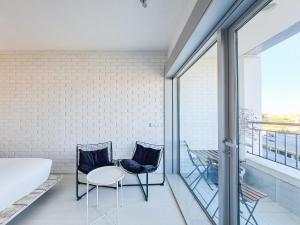 a room with two chairs and a table on a balcony at CM Antas Studios in Porto