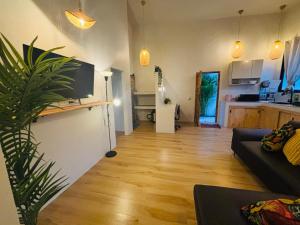 a living room with a couch and a kitchen at JK House in Hinkong