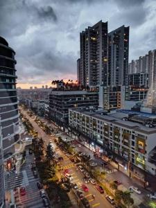 a city street with traffic in a city with tall buildings at Cozy Haven Queen Deluxe Studio 3 WI-FI Netflix in Petaling Jaya