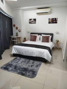 a bedroom with a large bed and a rug at Cozy Haven Queen Deluxe Studio 3 WI-FI Netflix in Petaling Jaya +16 photos