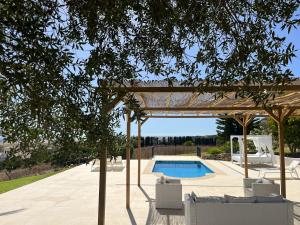 a pergola and a swimming pool in a yard at Finca la Vina in Vejer de la Frontera +39 photos
