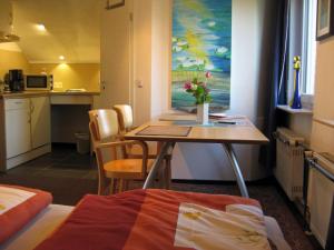 a small room with a table with flowers on it at Eva und Wolf Apartments in Sachsenheim