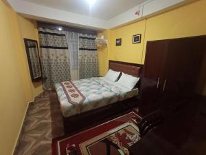 a small bedroom with a bed and a window at Hotel Parichit in Namchi