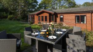 a table with plates of food on it in a backyard at Newby Bridge Country Caravan Park in Newby Bridge