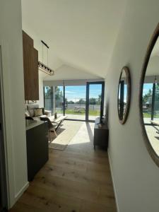 a hallway with a mirror and a living room at OS BALCONS RÍA DE AROUSA II in Boiro