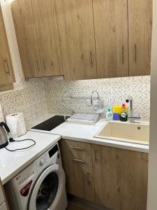 a kitchen with a washing machine and a sink at Votsala in Loutraki