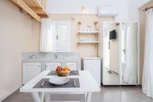 a kitchen with a table with a bowl of fruit on it at Santa Irini 2 in Vourvoúlos