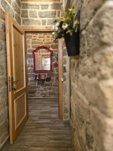 a hallway with a door and a vase with flowers at Sazeli Boutique Hotel in Baku