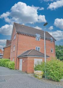 a brick building with a street light in front of it at Spacious Two Bedroom Hideaway in Wokingham with En Suite, Free Wi Fi and Parking, Sleeps Four in Wokingham +26 photos