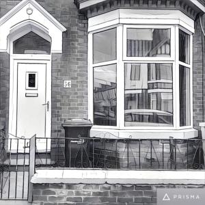 a black and white photo of a house with a window at Samuel Place by SG of Crewe - 5 Beds, 4 Bedrooms, 2 Bath in Crewe