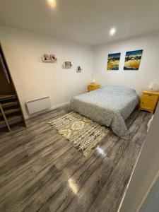 una camera da letto con un letto e un pavimento in legno di Proximité RER A , souplex tout confort, 2 chambres a Saint-Maur-des-Fossés