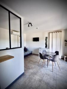 a dining room with a table and chairs in a room at Lodging Au Milieu des Vignes & des Étoiles in Saint-Jean-de-Fos +13 photos