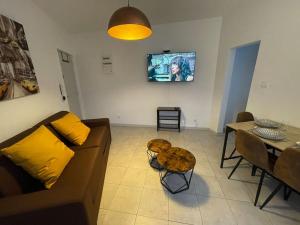 a living room with a couch and a table at Bel appartement Béziers - Clim - 1 Chambre - Gare - Centre in Béziers