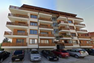 a large building with cars parked in front of it at Katerina Apartments 9 in Velingrad