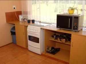 a kitchen with a microwave and a stove at Gateway Guesthouse in Benoni +19 photos