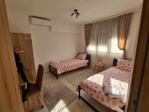a small room with two beds and a window at Sirob bubanj in Kragujevac