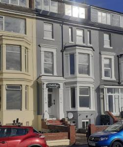 a house with a red car parked in front of it at Southbay Holiday Flats Flat 2 in Bridlington