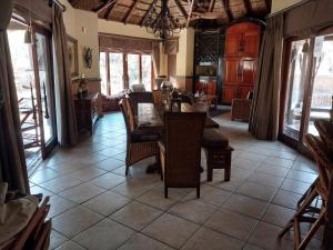 a dining room with a table and chairs at Assegai Lodge in Moheme