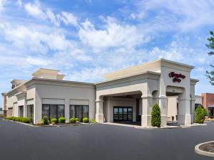 a large white building with a sign on it at Hampton Inn Blytheville in Blytheville