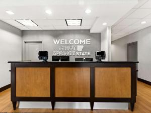 a welcome desk in a lobby with a welcoming sign at Hampton Inn Blytheville in Blytheville +22 photos