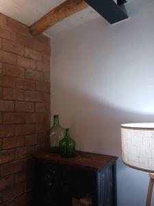 two green vases sitting on a table in a room at La Casa de mi Tía María in Cortelazor +20 photos