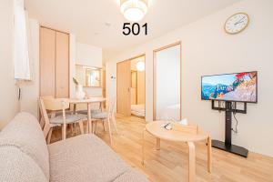 a living room with a couch and a table at Newly build Family-APT , Shinjuku Shibuya Ueno in 15 minutes by train in Tokyo