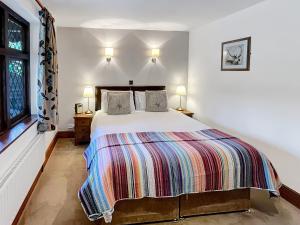 a bedroom with a bed and a window at Gardener’s Cottage Martinhoe in Martinhoe