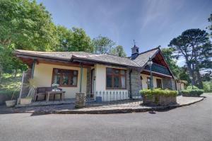 a small house with a table in front of it at Gardener’s Cottage Martinhoe in Martinhoe