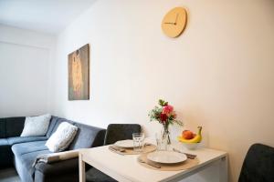 a living room with a table and a couch at Cozy 2-room apt, Parking nearby in Staré Mesto