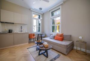 a living room with a couch and a table at The Zorbas Apartments in Mytilene