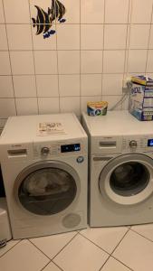 two washing machines sitting next to each other in a kitchen at Luxus pur Endhaus 3SZ mit Garten,Kamin, Klima, in Taufkirchen +31 photos