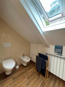 a bathroom with a toilet and a sink and a skylight at Casa Monnalisa - Calandre Sabbie Oro in Ventimiglia +45 photos
