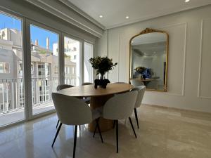 a dining room with a table and chairs and a mirror at Navas 202 Elegant Suite in Granada