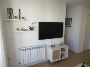 a living room with a flat screen tv on a wall at Vivienda turística El Caminante con garaje in Soria
