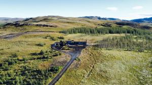 an aerial view of a train on the tracks in a field at Kambar in Selfoss