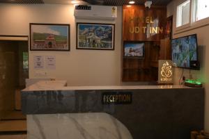 a room with a counter and posters on the wall at Hotel Udit Inn Rudraprayag in Rudraprayāg