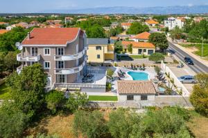 an aerial view of a house with a swimming pool at Villa Lea ZadarVillas in Zaton