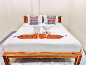 a bedroom with a bed with two shoes on it at PMS Boutique Patong in Patong Beach