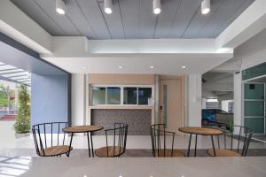 a group of chairs and tables in a lobby at B32 Apartment in Bangna