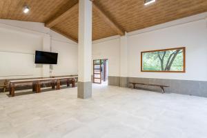 a large room with a flat screen tv on the wall at Rural Mas Vila in Fogás de Tordera