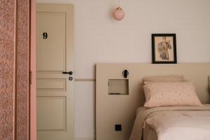 a bedroom with a bed and a white door at Villa Nady in Pauillac