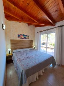 ein Schlafzimmer mit einem Bett und einem großen Fenster in der Unterkunft Candy Apart Hotel in Villa General Belgrano + 38 Fotos